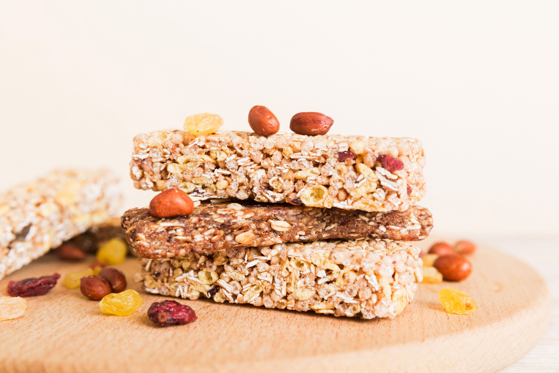 Various granola bars on table background. Cereal granola bars. Superfood breakfast bars with oats, nuts and berries, close up. Superfood concept