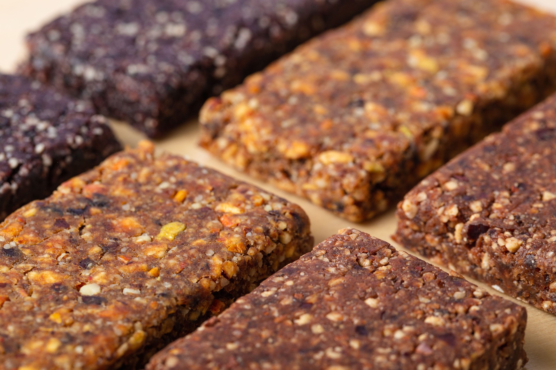 Close up macro of various hand made healthy granola bars (muesli or cereal bar) creative stock image